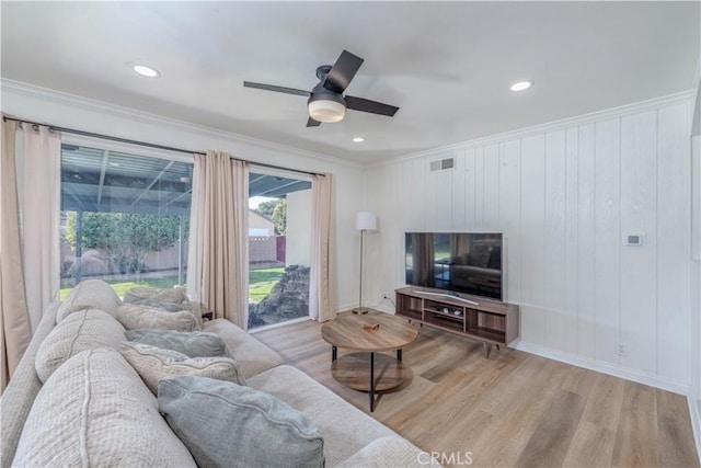 living room with visible vents, ornamental molding, wood finished floors, and recessed lighting