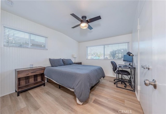 bedroom featuring a ceiling fan, lofted ceiling, and light wood-type flooring