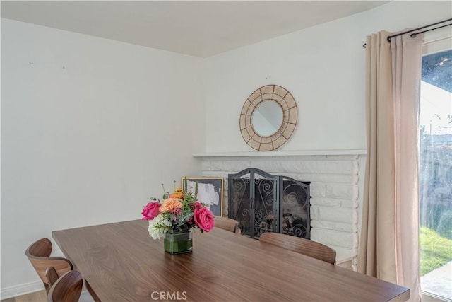 dining area with a fireplace and a healthy amount of sunlight