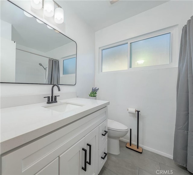 bathroom with vanity, curtained shower, tile patterned floors, toilet, and baseboards