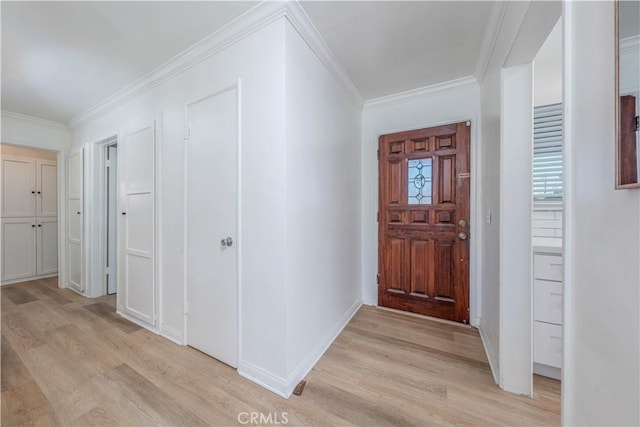 entrance foyer featuring baseboards, light wood-style floors, and crown molding