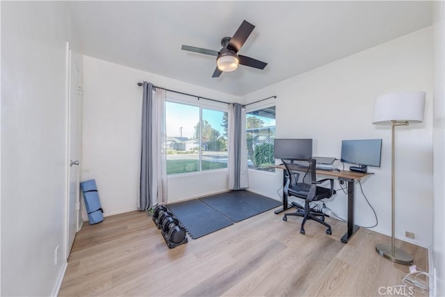 home office with baseboards, wood finished floors, and a ceiling fan