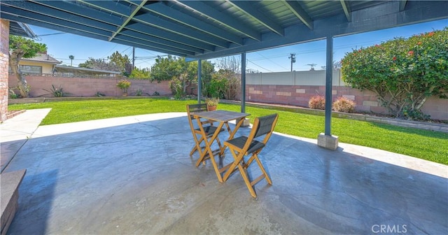 view of patio featuring outdoor dining space and a fenced backyard