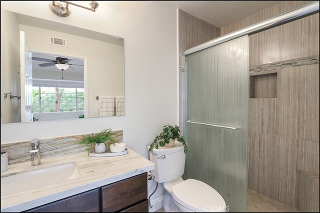 full bath featuring visible vents, ceiling fan, toilet, a stall shower, and vanity