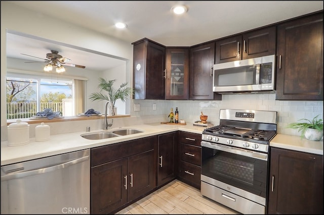 kitchen with stainless steel appliances, light countertops, and a sink