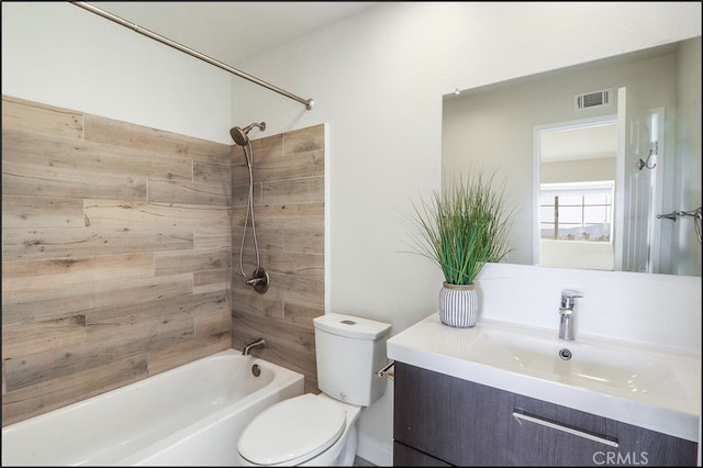 full bath with visible vents, toilet, vanity, and bathtub / shower combination