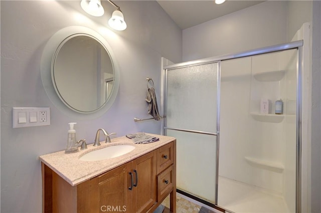 bathroom featuring a shower stall and vanity