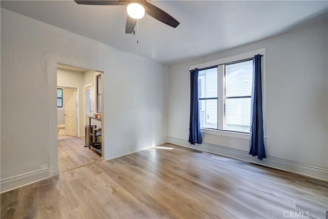 empty room featuring light wood-style floors and a ceiling fan