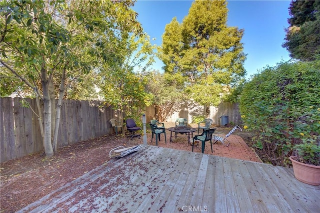 deck featuring a patio and a fenced backyard