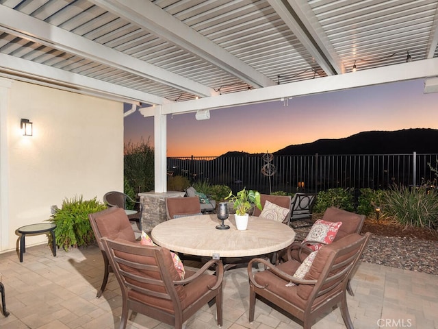 view of patio / terrace with outdoor dining space, fence, and a pergola