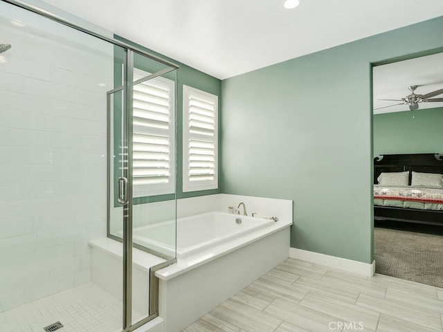 ensuite bathroom featuring a stall shower, baseboards, a ceiling fan, connected bathroom, and a bath