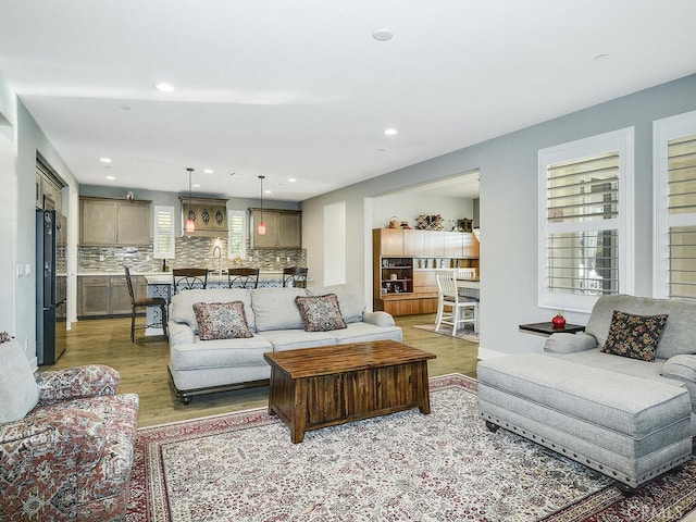 living room with recessed lighting and light wood finished floors