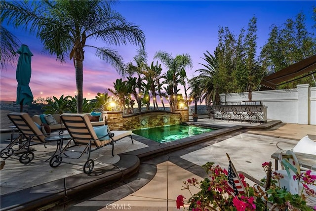 outdoor pool with fence and a patio