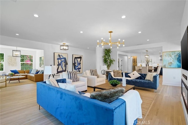 living area with a chandelier, recessed lighting, and light wood finished floors