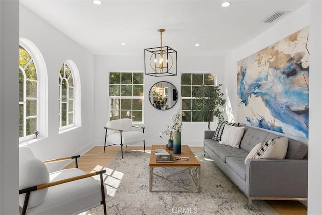 sitting room featuring recessed lighting, a notable chandelier, wood finished floors, visible vents, and baseboards