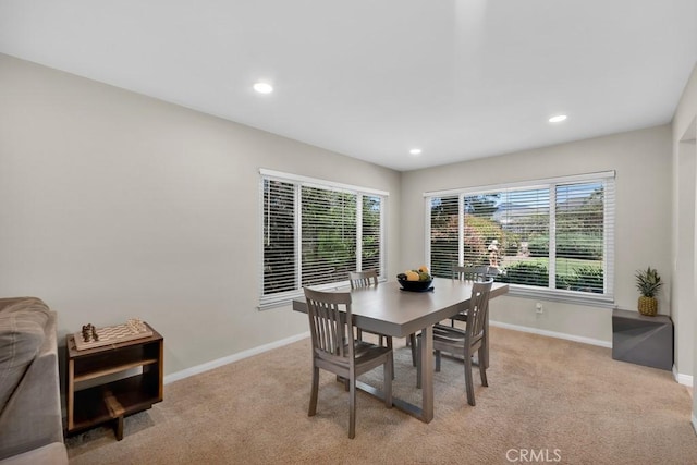 dining space featuring baseboards, light carpet, and recessed lighting