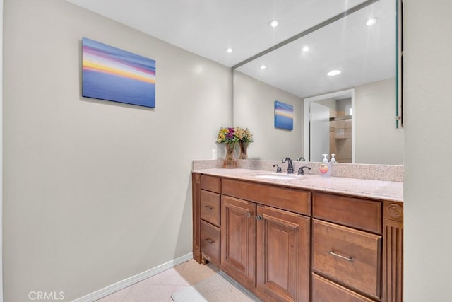 bathroom featuring recessed lighting, tile patterned floors, baseboards, and vanity
