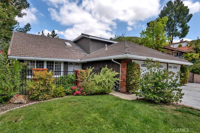 single story home featuring an attached garage, board and batten siding, a front yard, and concrete driveway