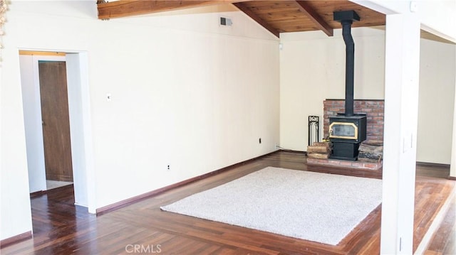 unfurnished living room with vaulted ceiling with beams, wooden ceiling, wood finished floors, visible vents, and a wood stove