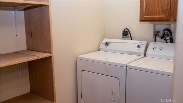 laundry room featuring washer and dryer and cabinet space