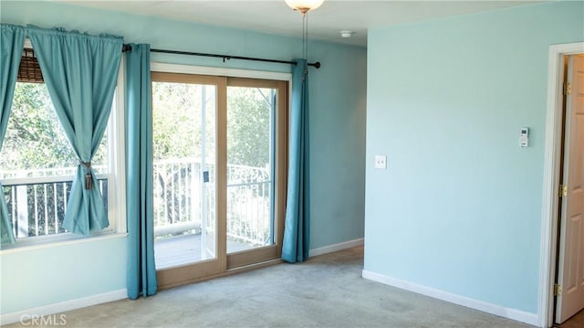 doorway to outside with carpet and baseboards