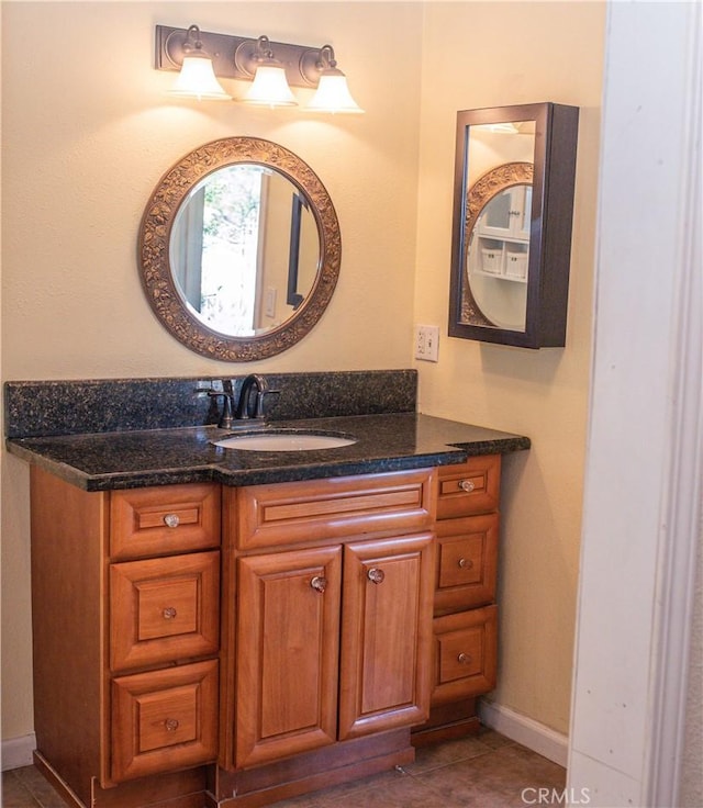 bathroom with tile patterned flooring, vanity, and baseboards