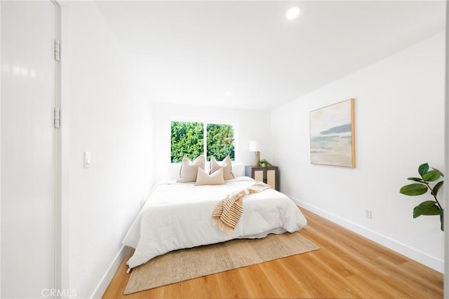 bedroom featuring recessed lighting, light wood-type flooring, and baseboards