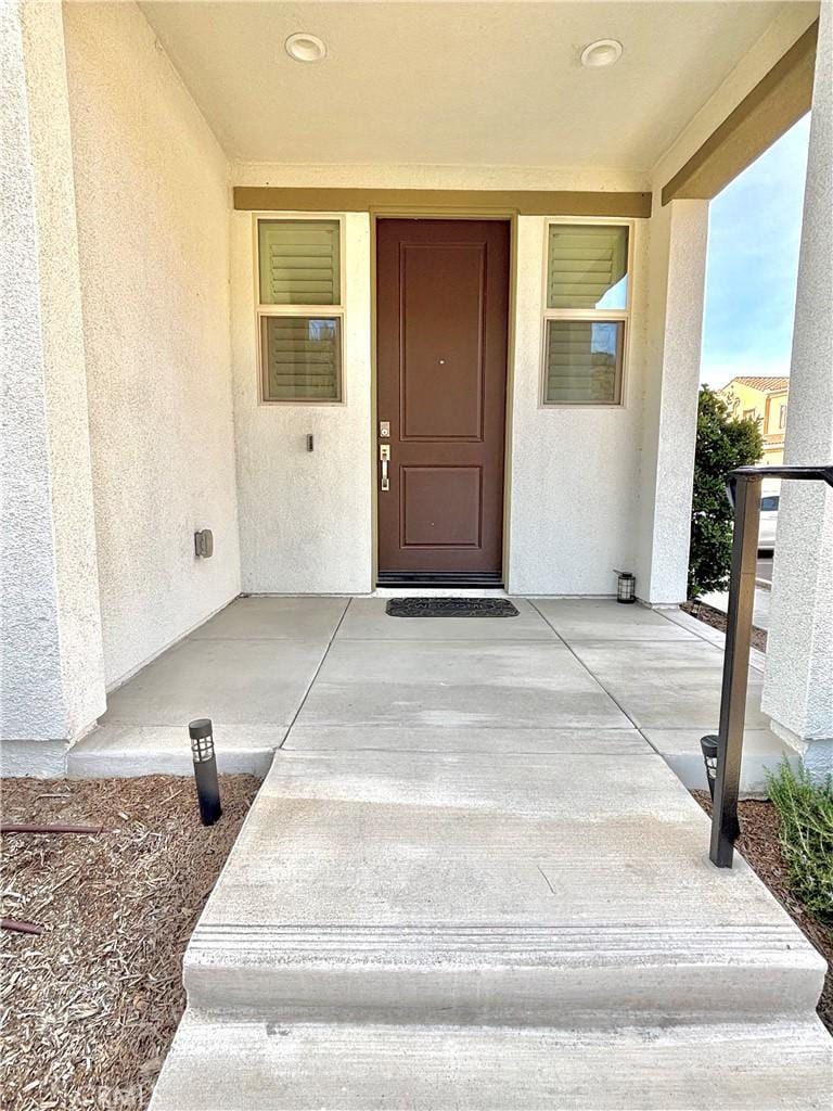 property entrance with stucco siding