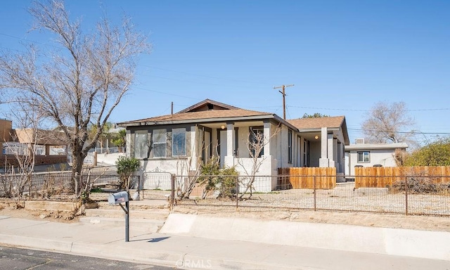 bungalow-style house with a fenced front yard