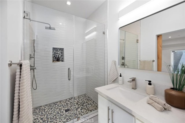 bathroom featuring a stall shower and vanity