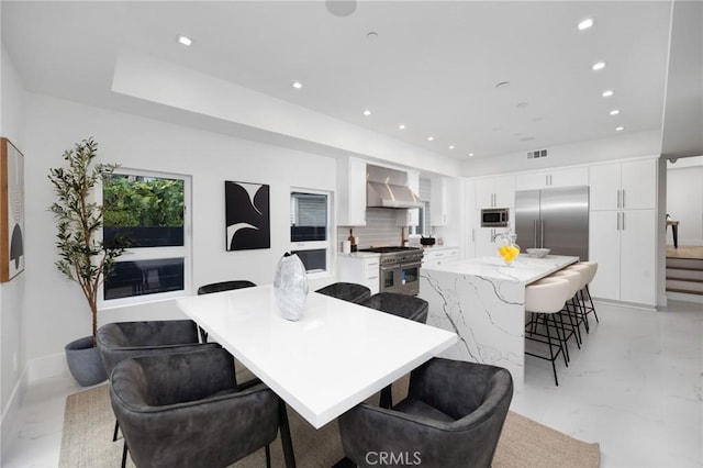 dining area featuring recessed lighting, marble finish floor, visible vents, and stairs