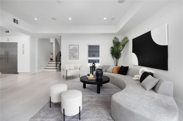 living area with stairs, visible vents, and recessed lighting