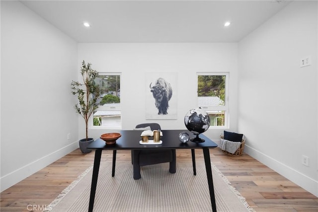 office featuring baseboards, recessed lighting, a wealth of natural light, and light wood-style floors