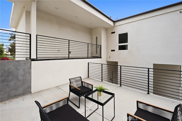 view of patio featuring a balcony