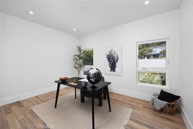 home office with recessed lighting, light wood-type flooring, and baseboards