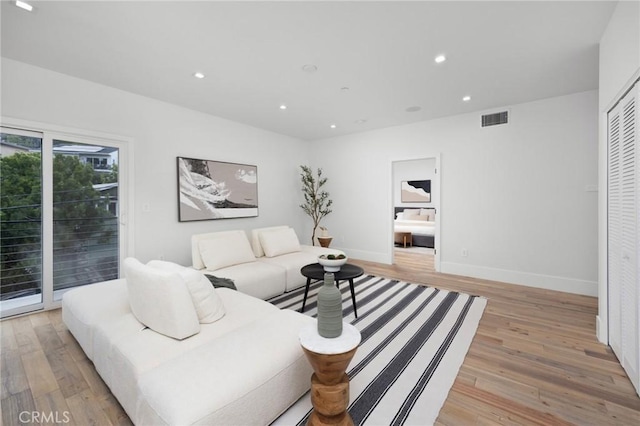 living area featuring recessed lighting, visible vents, and light wood finished floors