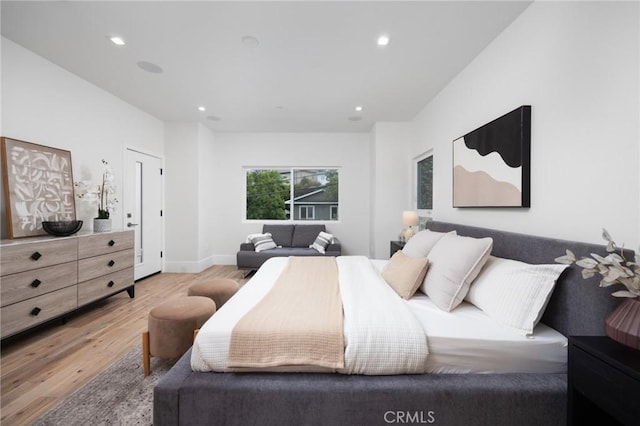 bedroom featuring light wood-type flooring, baseboards, and recessed lighting