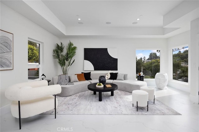 living area with recessed lighting and marble finish floor