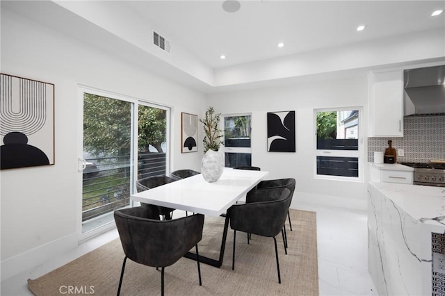 dining area featuring baseboards, a healthy amount of sunlight, visible vents, and recessed lighting