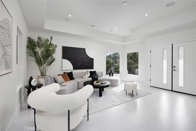 living room with a tray ceiling and recessed lighting