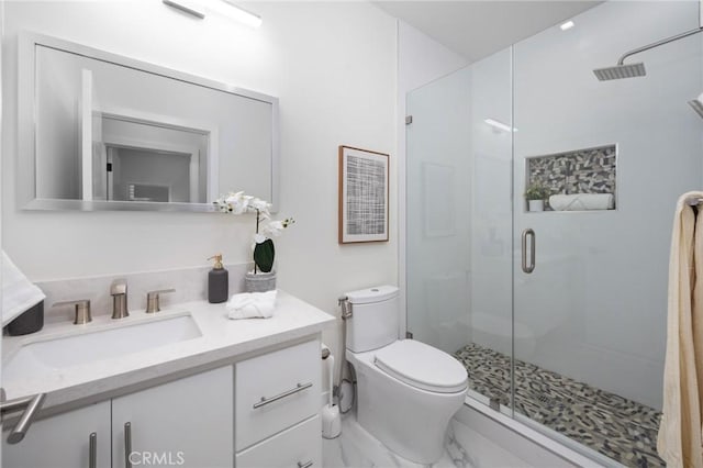 full bathroom featuring toilet, a stall shower, marble finish floor, and vanity