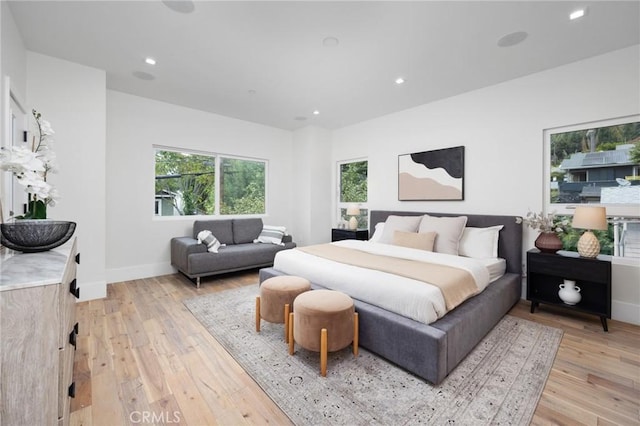 bedroom with recessed lighting, baseboards, and light wood finished floors