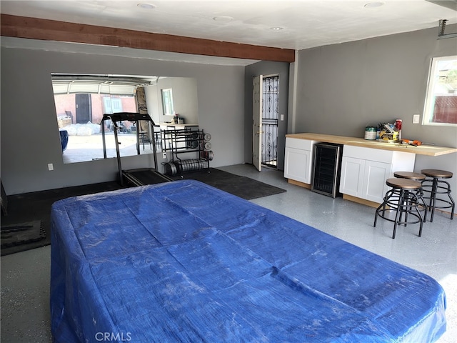 bedroom featuring wine cooler and a dry bar