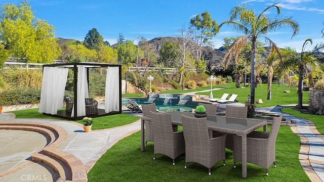 view of patio featuring outdoor dining space, an outdoor pool, and a mountain view