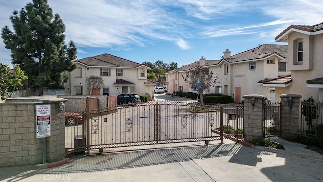 view of gate with a residential view and fence