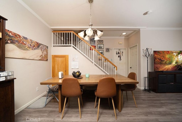 dining area featuring stairway, baseboards, ornamental molding, and wood finished floors