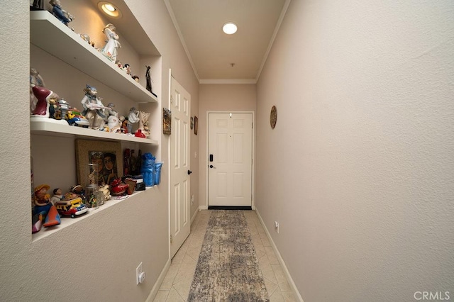 doorway to outside with baseboards and ornamental molding