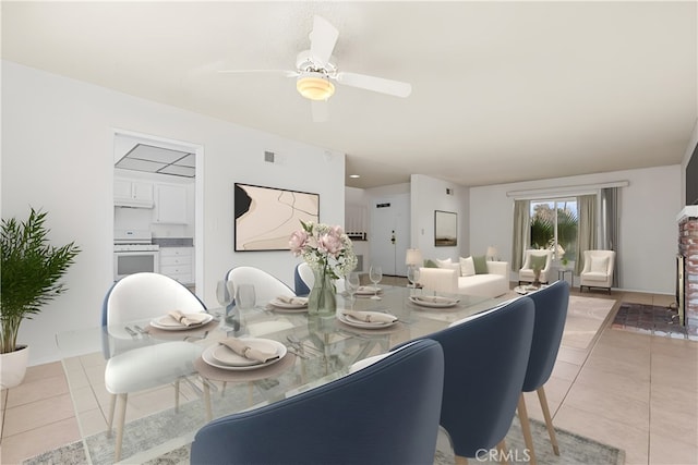 dining space with light tile patterned flooring, ceiling fan, and visible vents