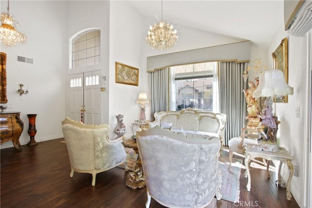 interior space with high vaulted ceiling, wood finished floors, visible vents, baseboards, and an inviting chandelier