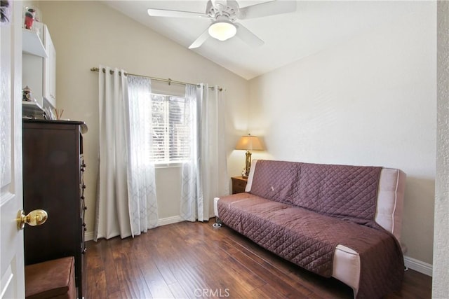 sitting room featuring a ceiling fan, vaulted ceiling, baseboards, and wood finished floors